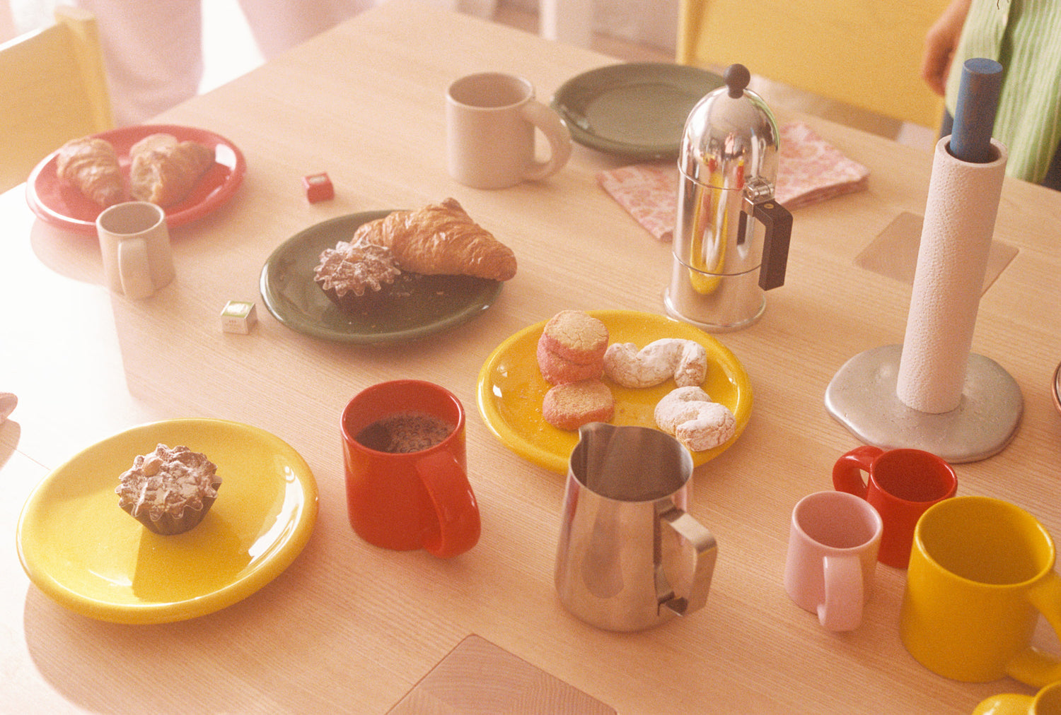 A lifestyle image of a breakfast scene featuring Spill Kitchen Roll Holder and Bronto Tableware on top of a Max Table.