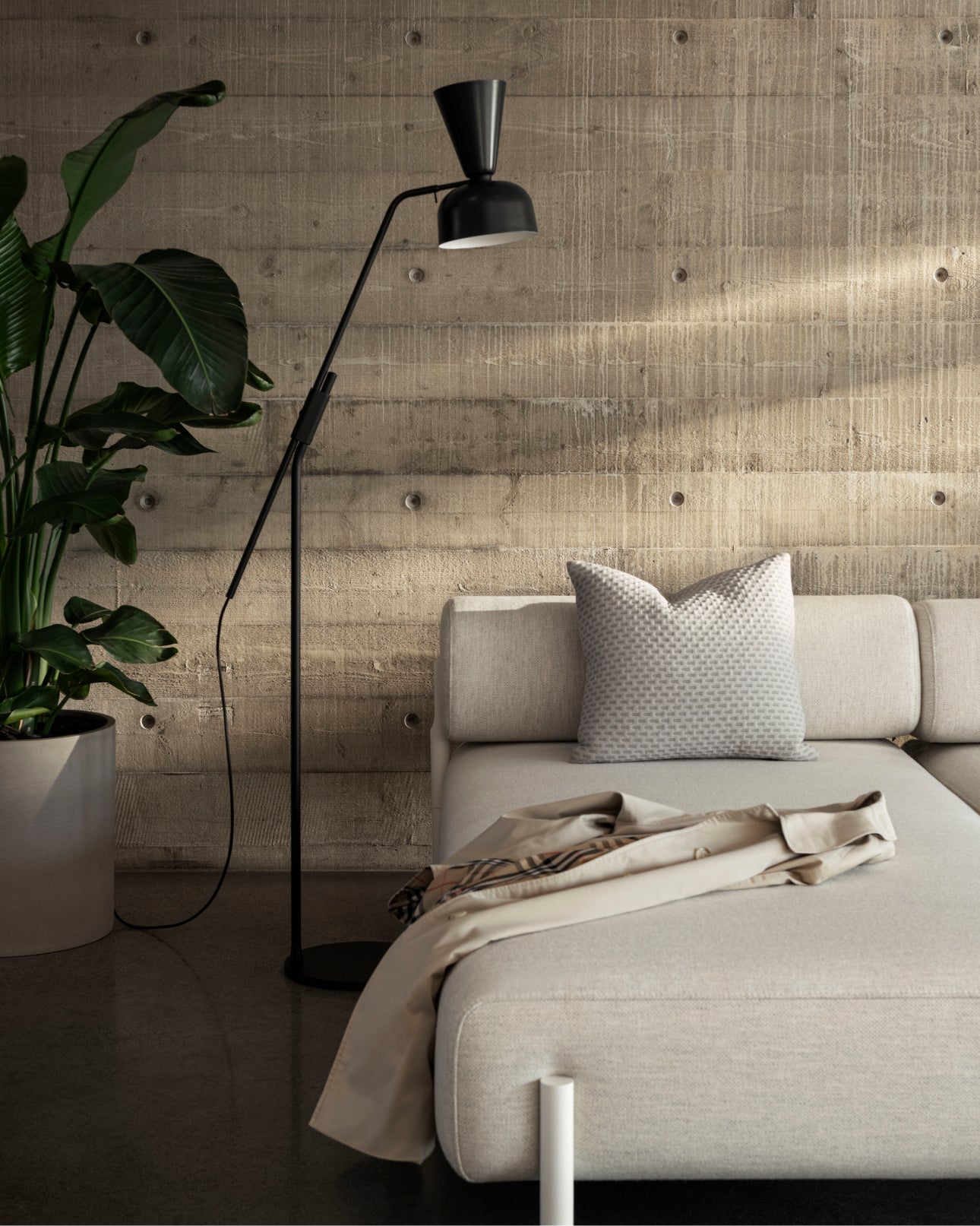 A lounge scene featuring the Alphabeta Floor Lamp standing next to a Palo Sofa.