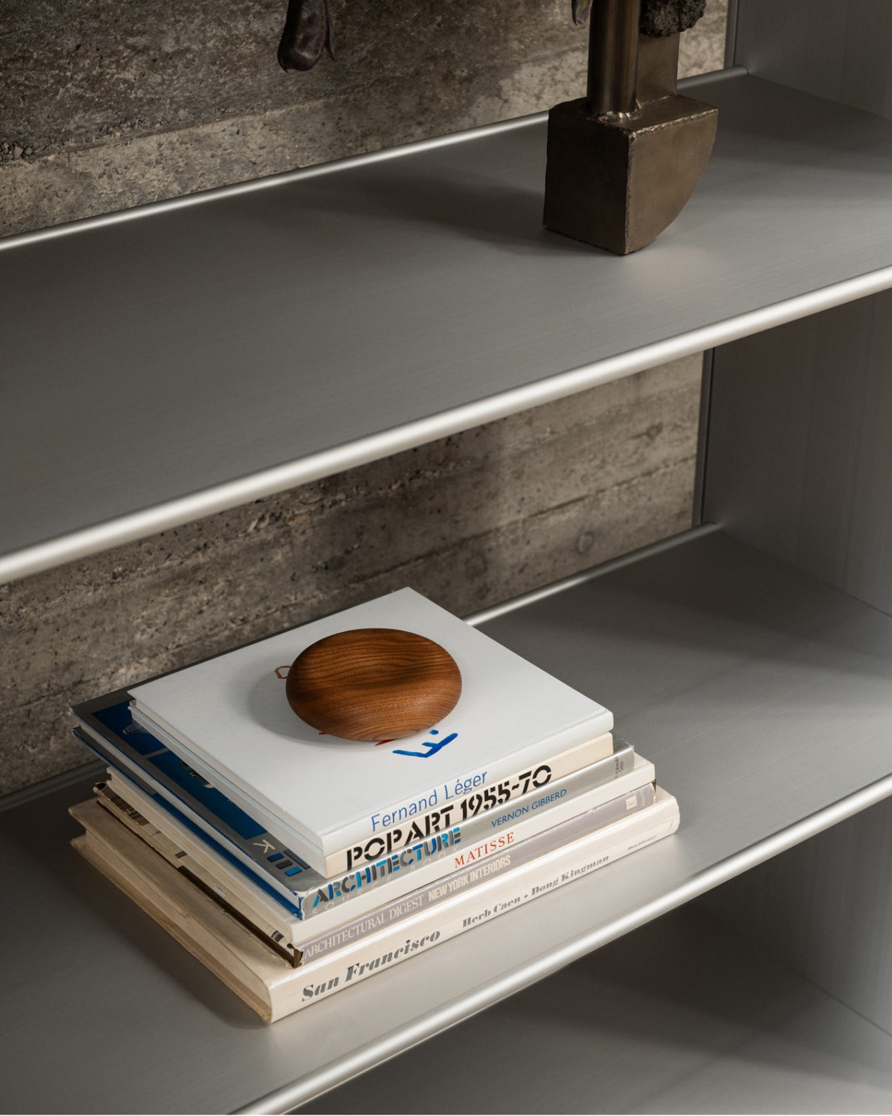 A close up image of a T Shelf with books and other decorative objects.