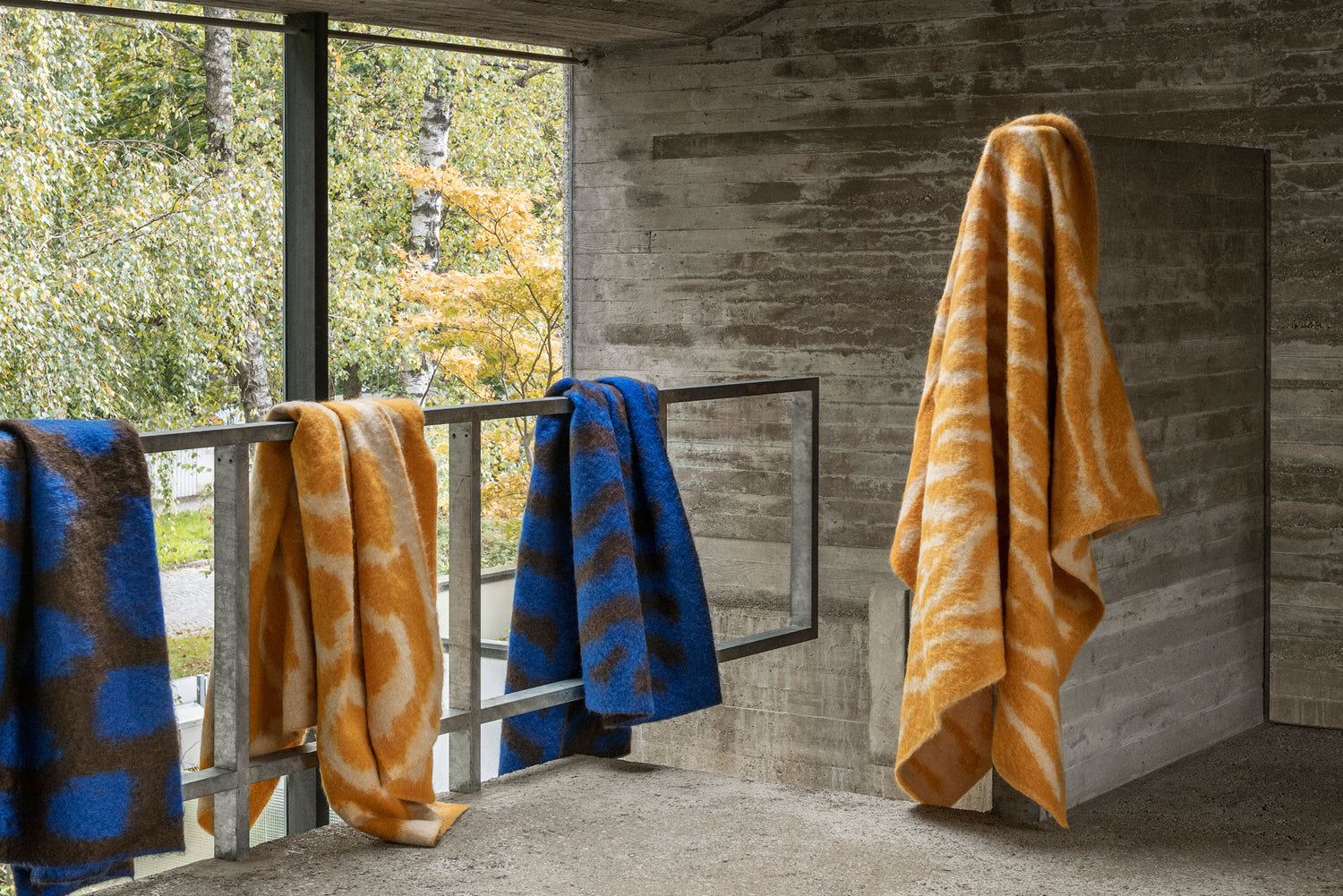 A landscape image featuring 4 Monster Throws draped over a railing.