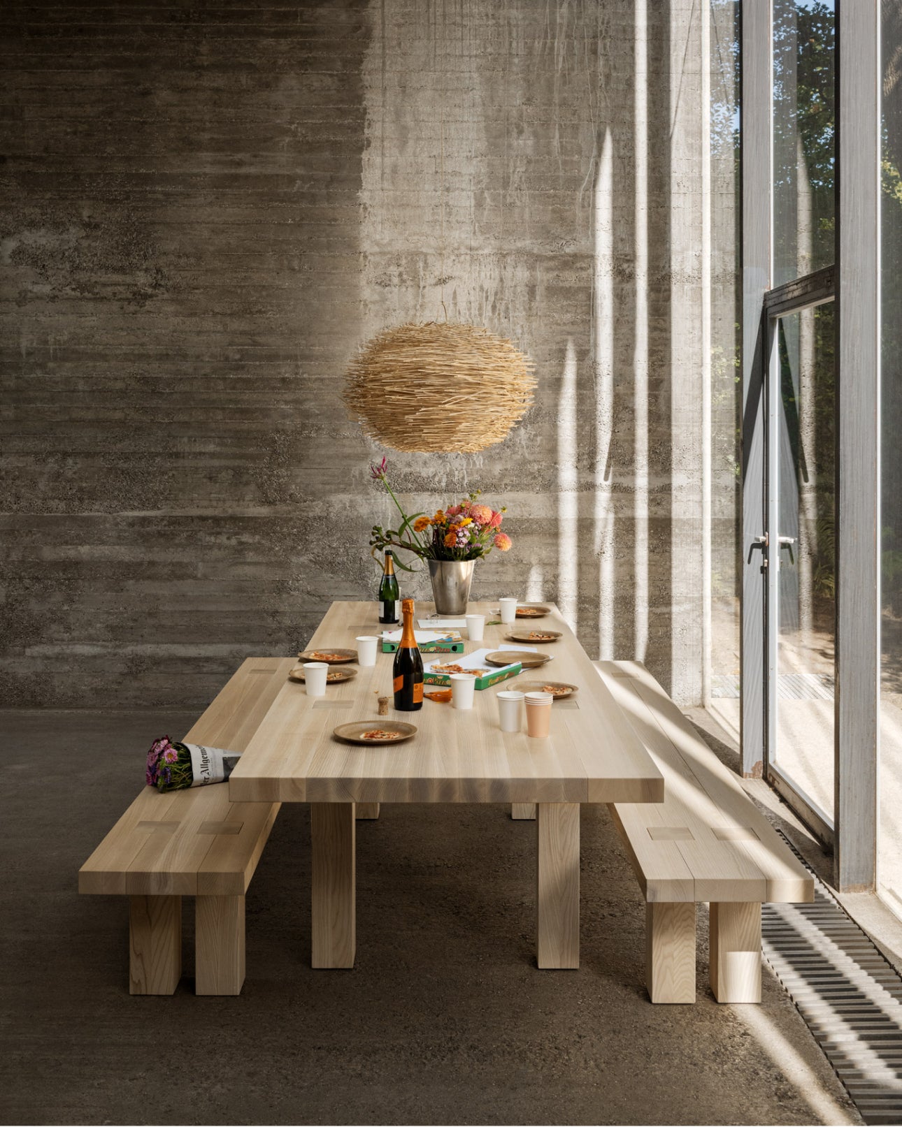 A dining scene featuring a Max Table + Benches Set.