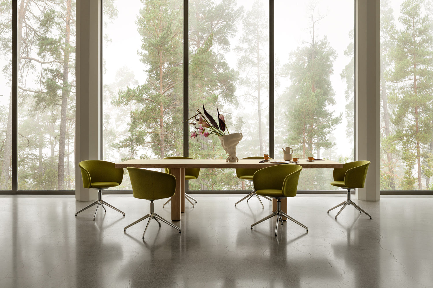 A lifestyle image of an office scene featuring Max Table and Kendo Chairs.